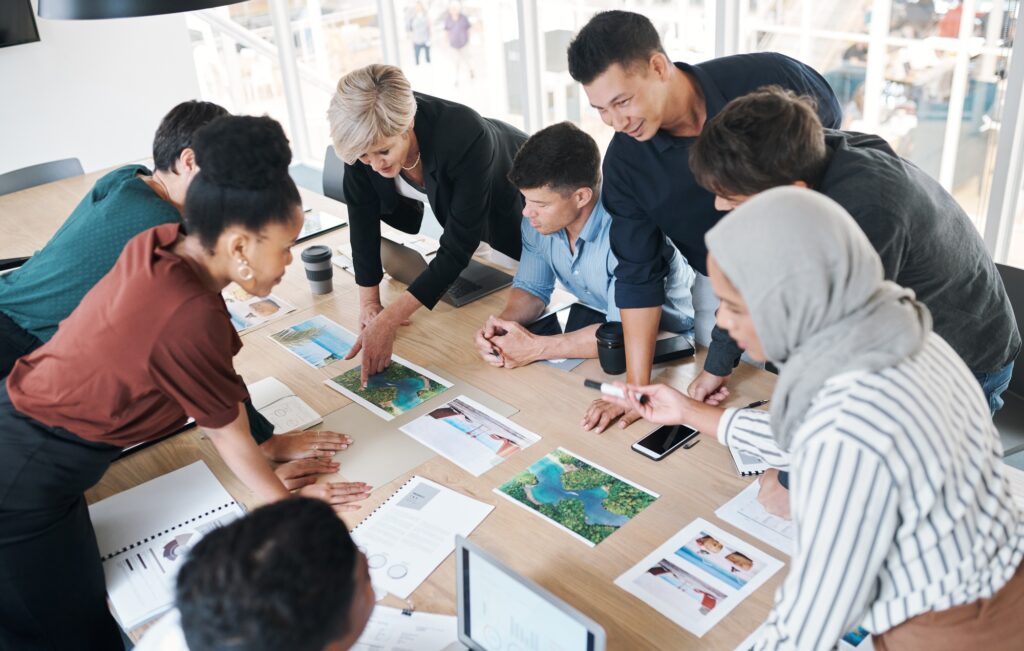 Shot of a group of businesspeople discussing paperwork during a meeting in a modern office