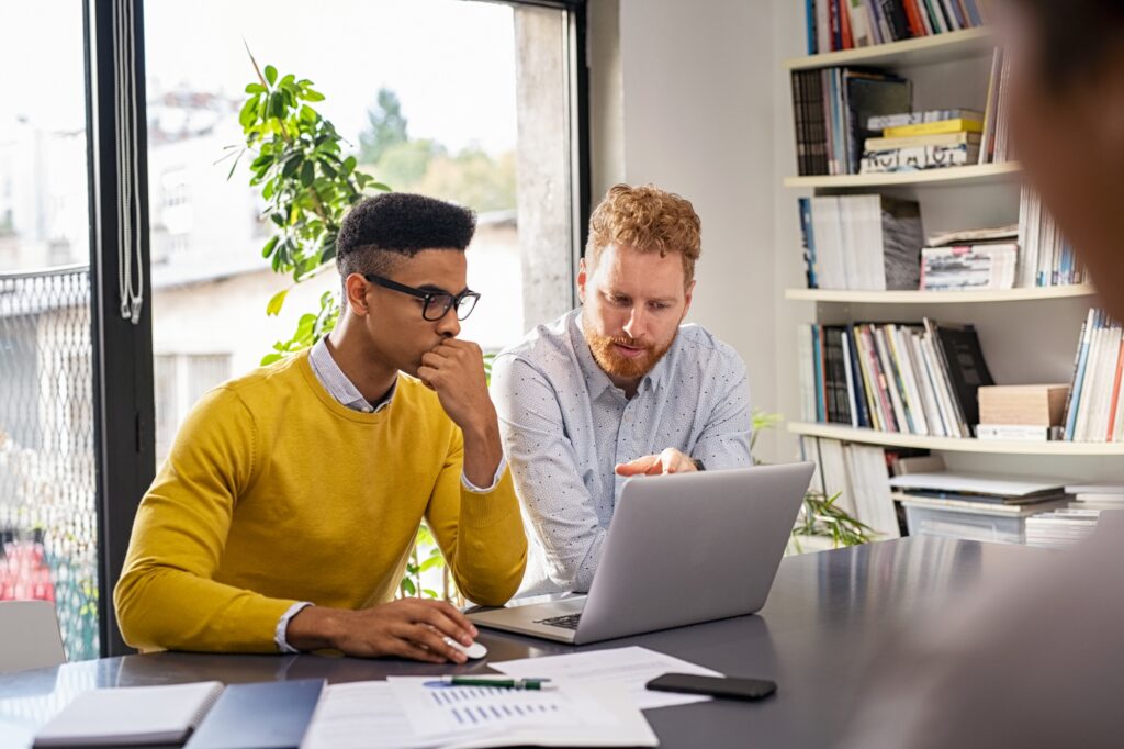 Creative business people working on laptop